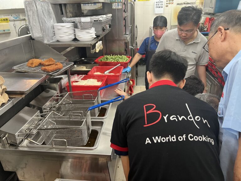 People gathering around Brandon's fryer to checkout