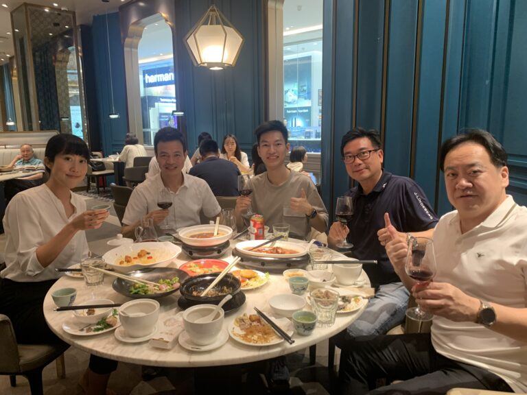 a group of people posing for a photo in a Chinese restaurant