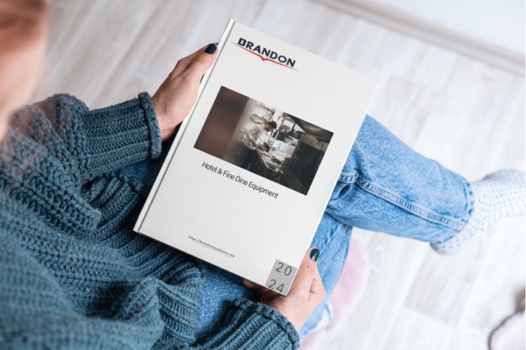 The image shows a person sitting comfortably in a relaxed environment, holding a catalog. The cover of the catalog prominently features the